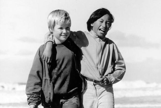 Two children on the beach - one Māori and one pakeha
