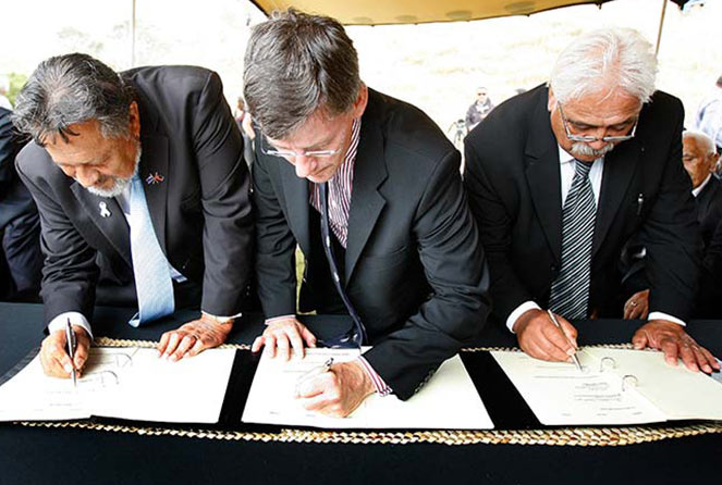 Government Minster and Iwi representatives sign a Treaty Settlement